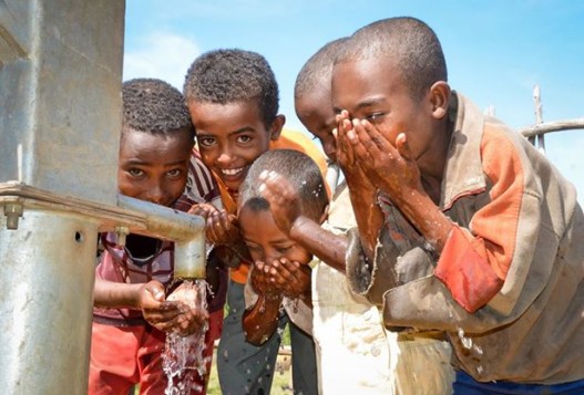 Water pic of children at well